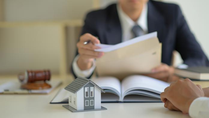 Closeup of photo a man holding paperwork at a desk